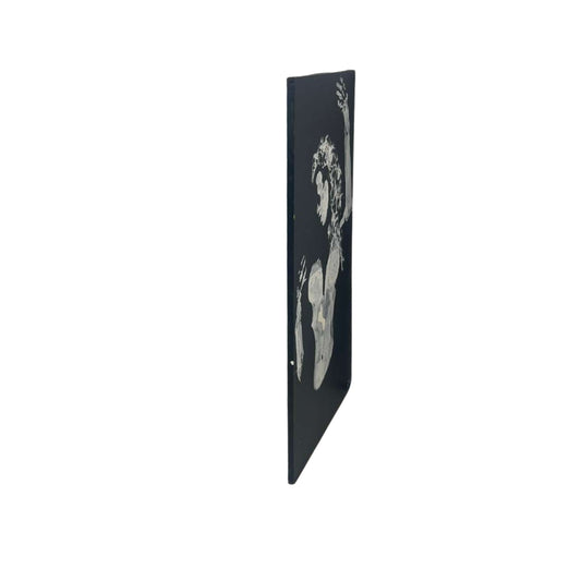 Side view of wall art of legs and breasts on a white background