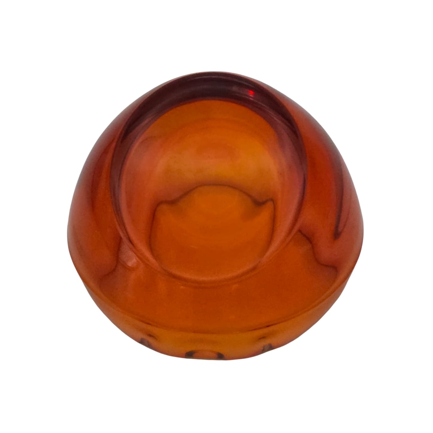 Bottom view of an orange glass ashtray on a white background
