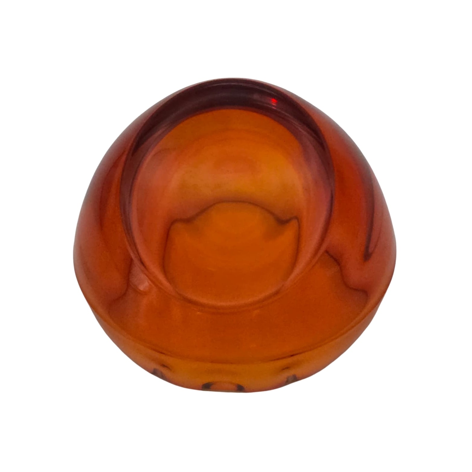 Bottom view of an orange glass ashtray on a white background