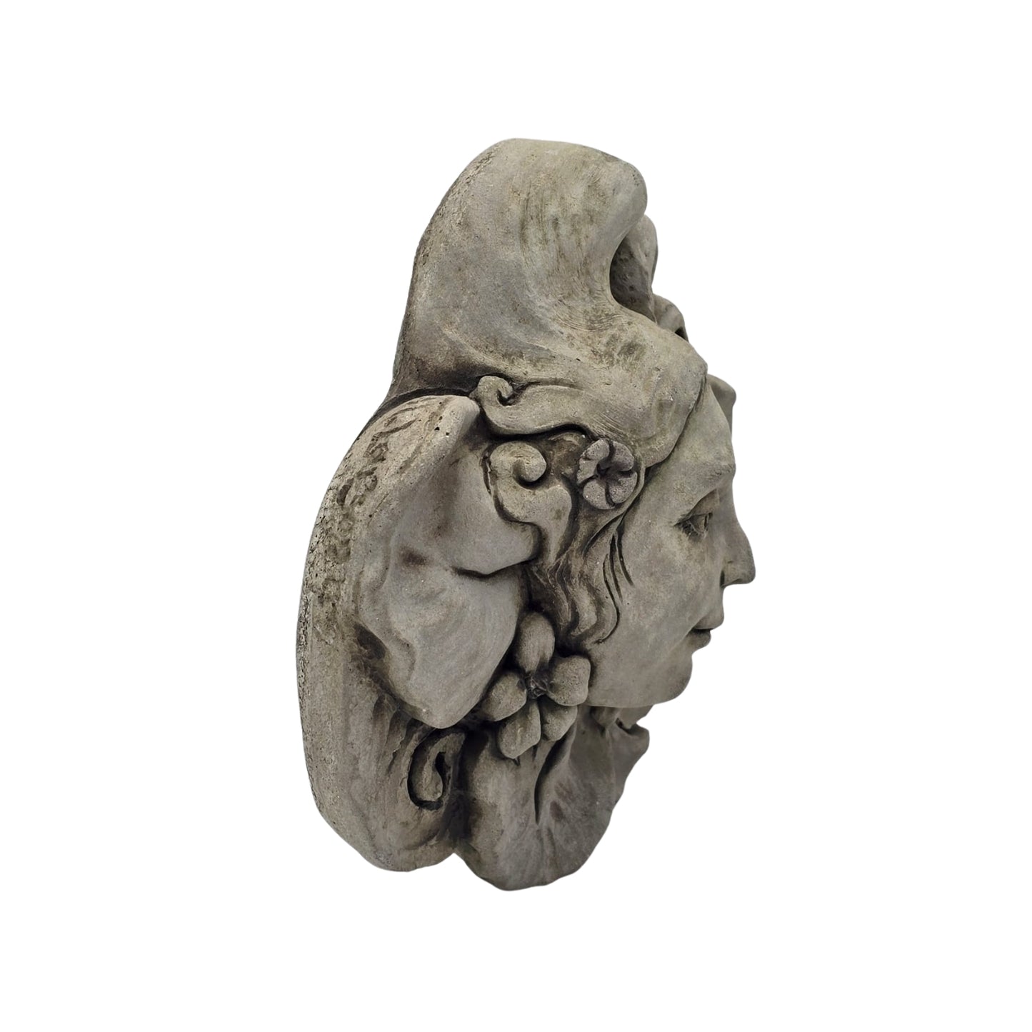 Side view of decorative stone wall plaque with face and floral design on white background