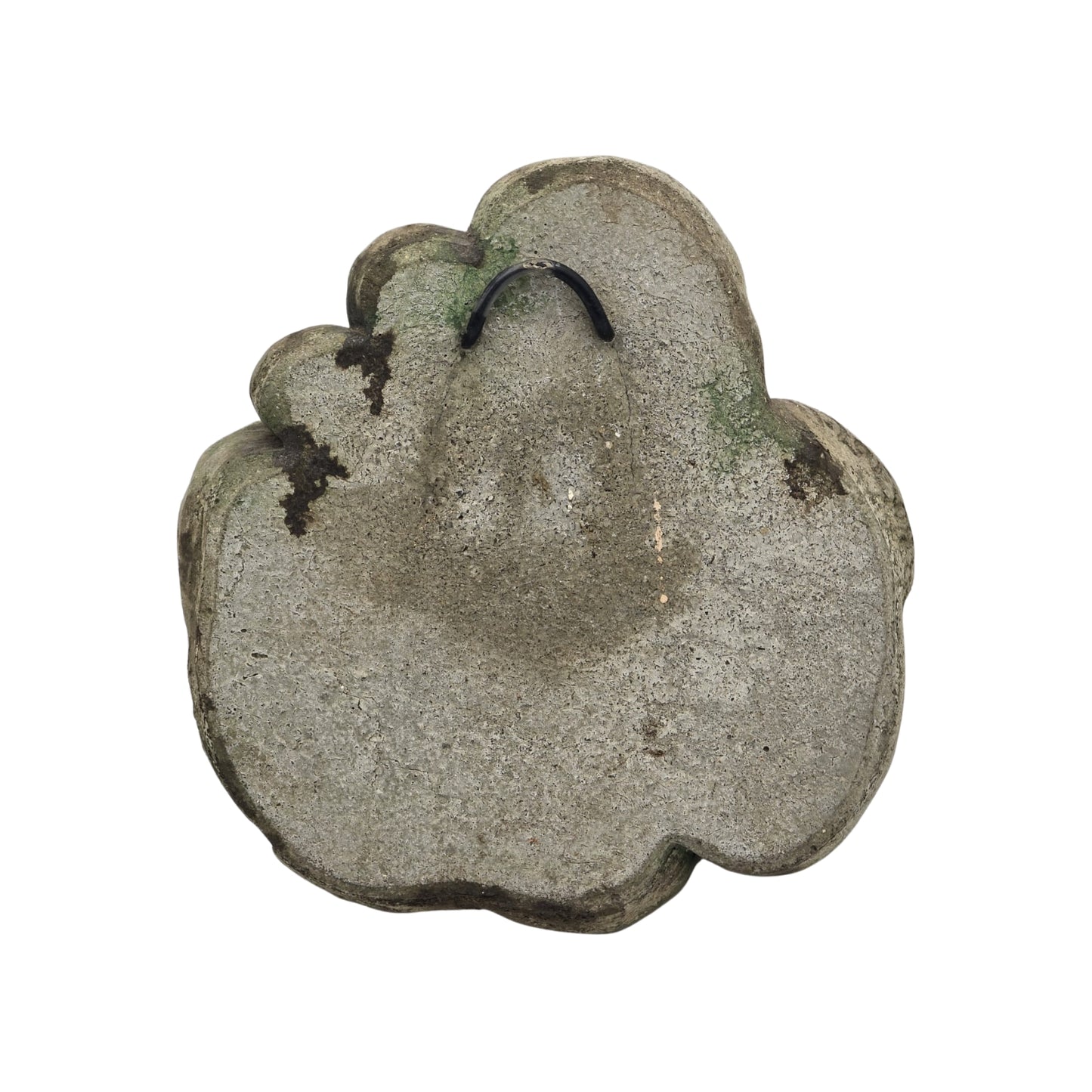 Back view of decorative stone wall plaque with face and floral design on white background