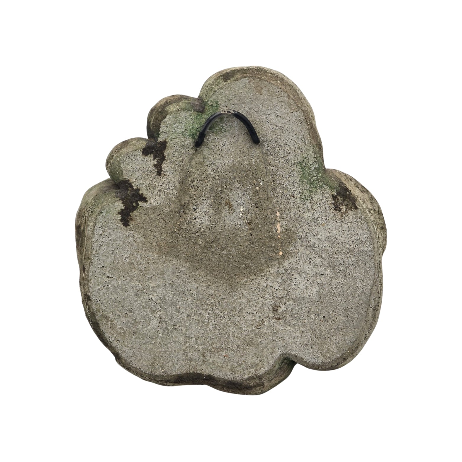 Back view of decorative stone wall plaque with face and floral design on white background